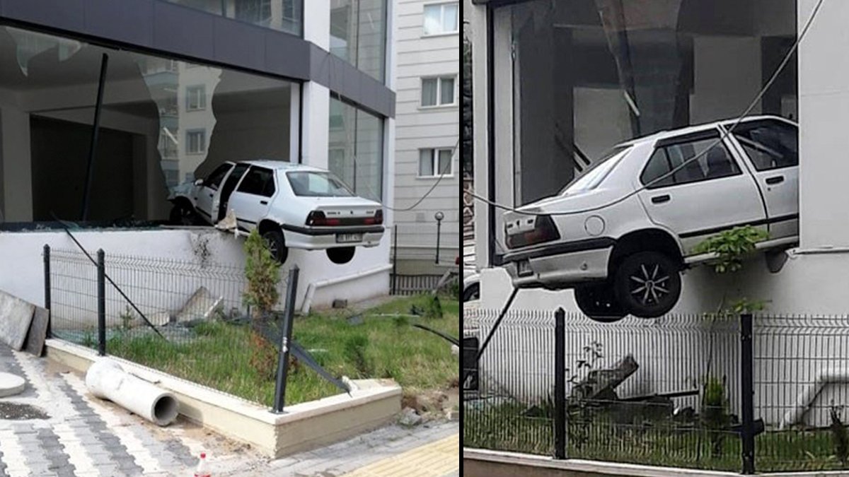 Havalanan otomobil binada asılı kaldı