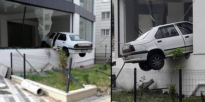 Havalanan otomobil binada asılı kaldı
