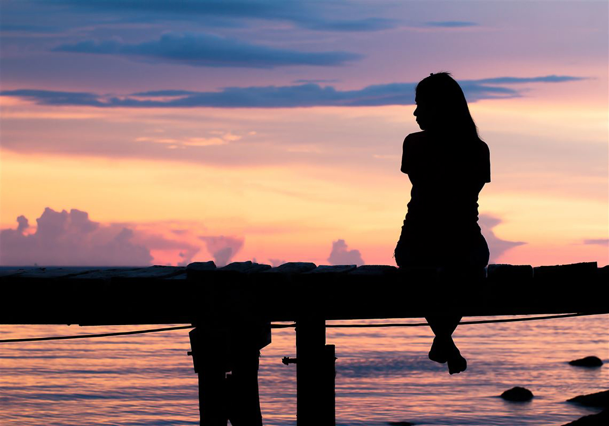 lonely-woman-sitting-on-a-wooden-bridge-sunset-style-abstract-1687487934.jpg