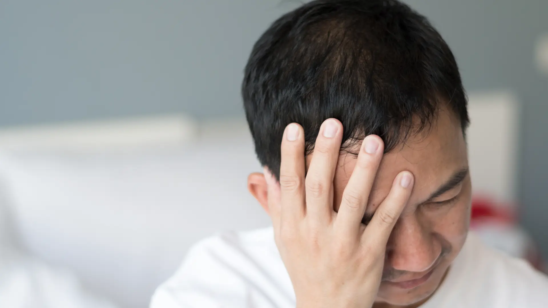 person-holding-head.webp