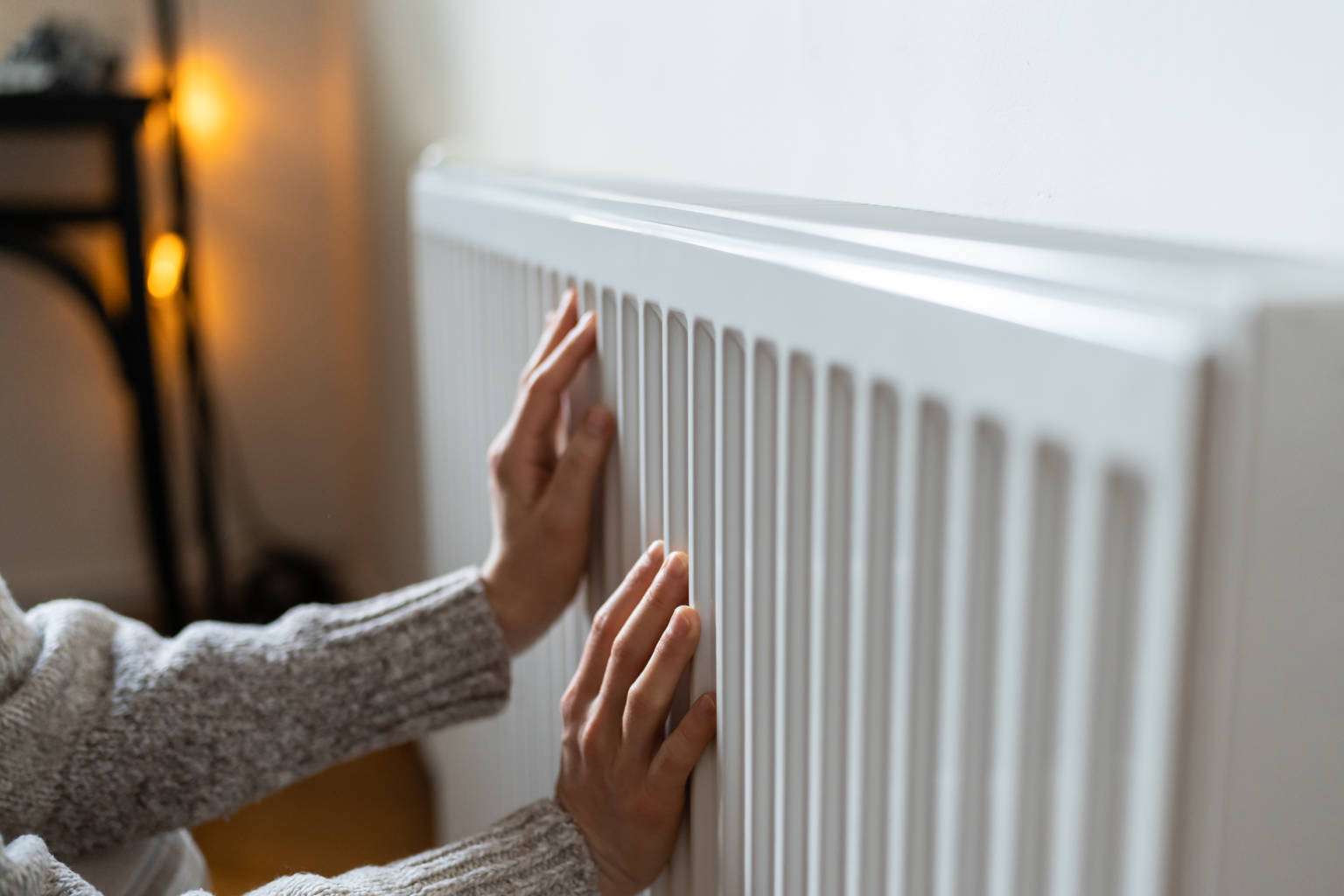 closeup-of-woman-in-sweater-puts-hands-on-room-cen-2023-11-27-05-33-11-utc-1536x1024.jpg