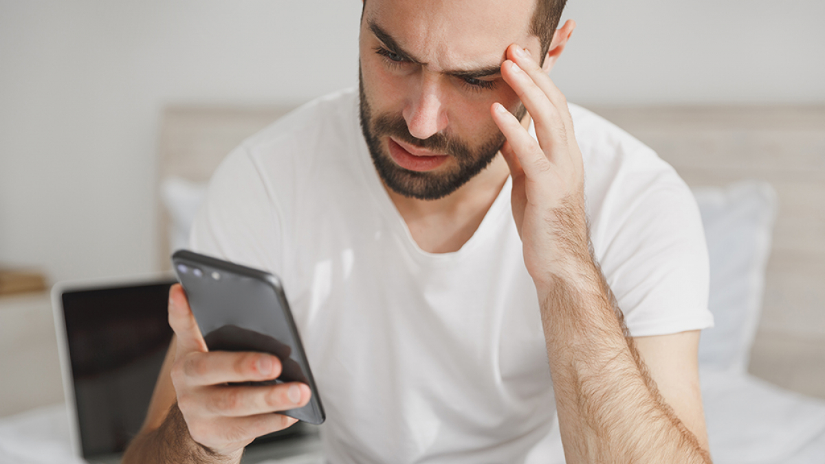 young-handsome-bearded-man-sitting-bed-with-white-sheet-pillow-blanket-bedroom-home-1200x675