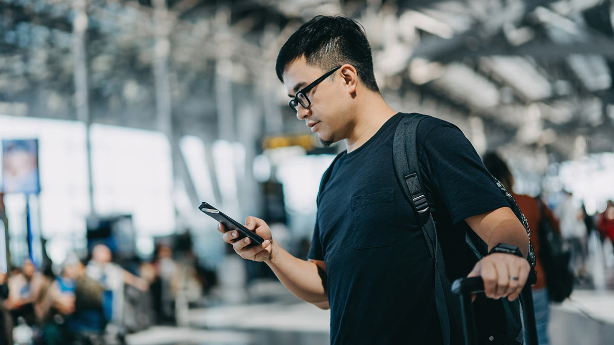 man-in-airport-on-phone-1200x675-gettyimages-1178814017