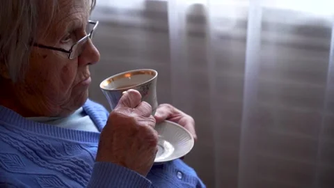 old-lady-drinking-tea-while-footage-133052185-iconl.webp